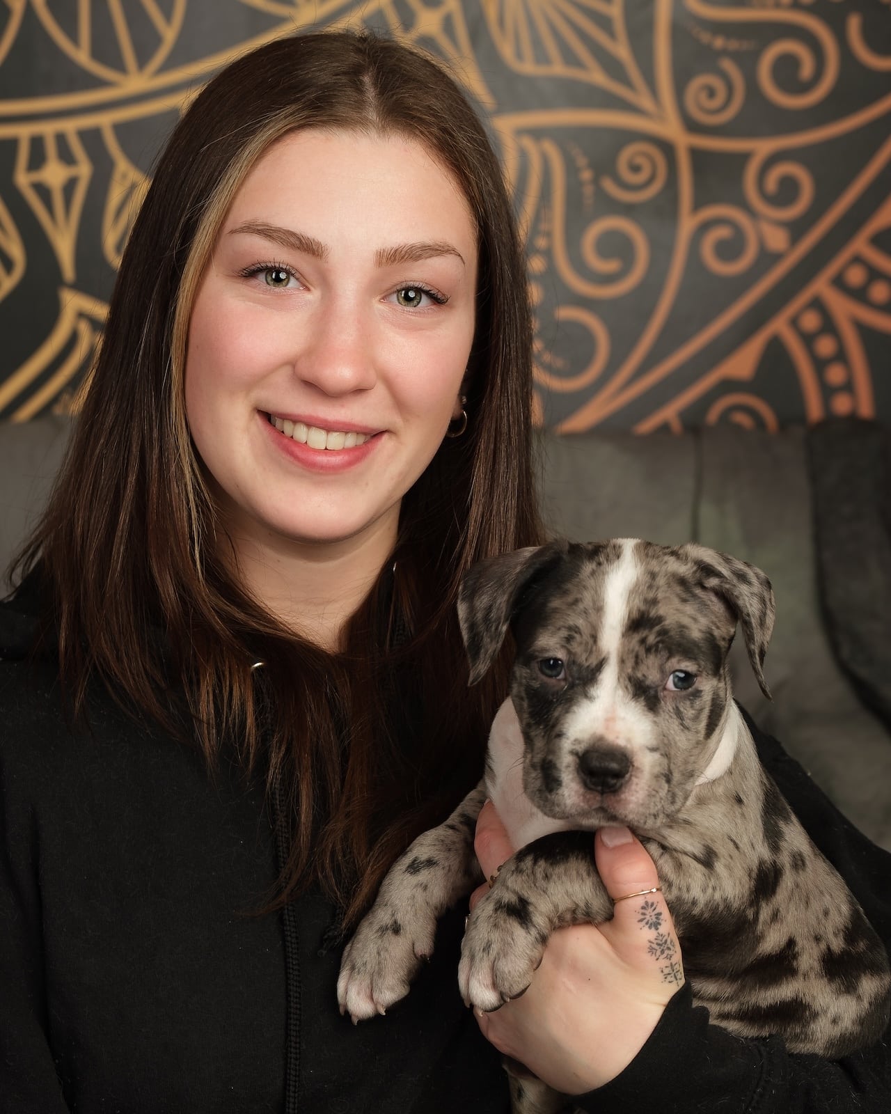 South of Heaven Tattoo artist Erin holding a puppy