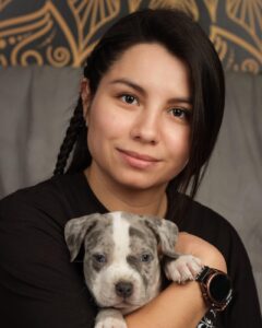 South of Heaven tattoo artist Laura holding a puppy